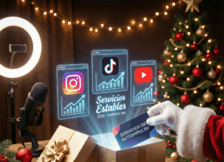 Lo que Santa trajo de Instante.net para tus redes: servicios estables para 2026 Fotografía de estilo navideño que muestra una mano con un guante de Santa Claus depositando una tarjeta azul con el texto "SERVICIOS DE AUTOIMPULSO" dentro de una caja de regalo dorada y abierta sobre una mesa de madera rústica. De la caja emergen iconos holográficos brillantes de Instagram, TikTok y YouTube, cada uno con gráficos de crecimiento ascendente, y el texto "Servicios Estables 2026 - Instante.net" en el centro. El fondo festivo incluye un árbol de Navidad decorado e iluminado, luces cálidas, un micrófono profesional y un anillo de luz.